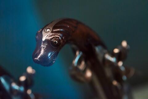 Détail sur la crosse d'un pistolet dit Chien de mer en forme de tête de chien