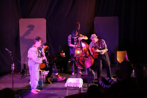 Groupe de musique sur scène, clarinette, contrebasse, guitares